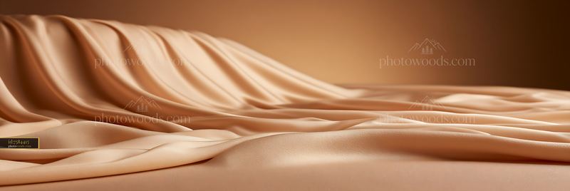 Soft beige fabric draping over a surface in warm lighting