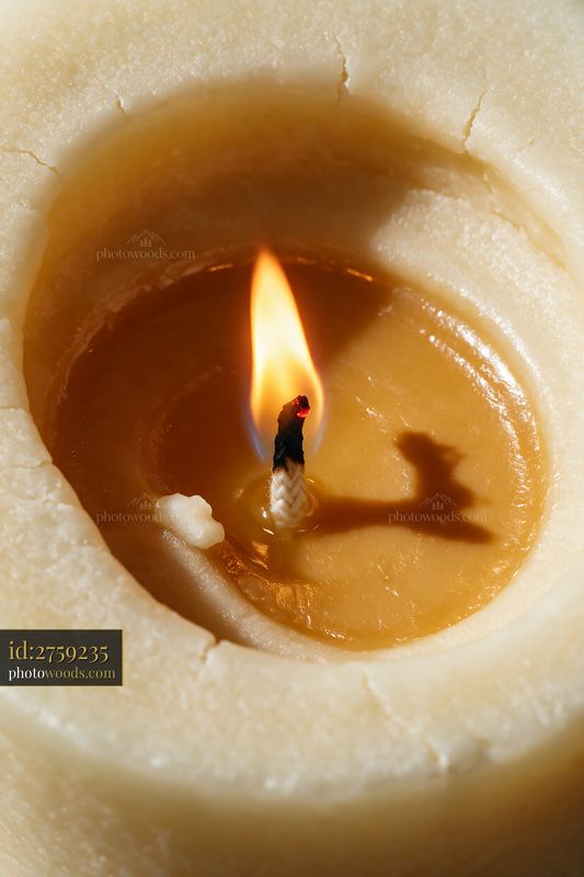 Macro View of a Burning Candle Flame in Melted Wax