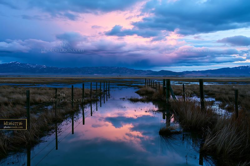 Thunderstorm brewing over a mountain range at dusk