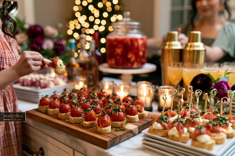 Christmas party appetizers on serving board with drinks