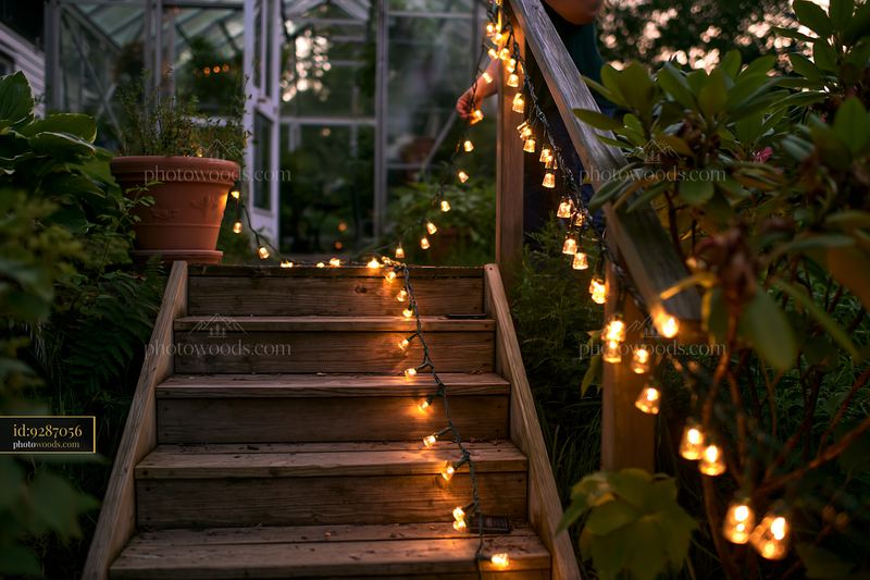 Hanging lights along staircase in outdoor garden setting