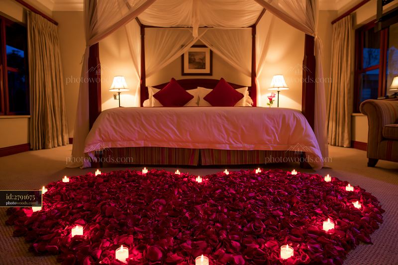 Heart-shaped flower petals and candles for anniversary