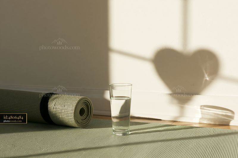 Heart-shaped window shadow on a sunlit interior wall