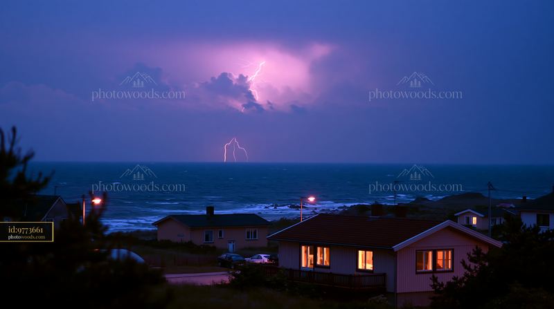 Lightning over a coastal ocean and seaside homes at night