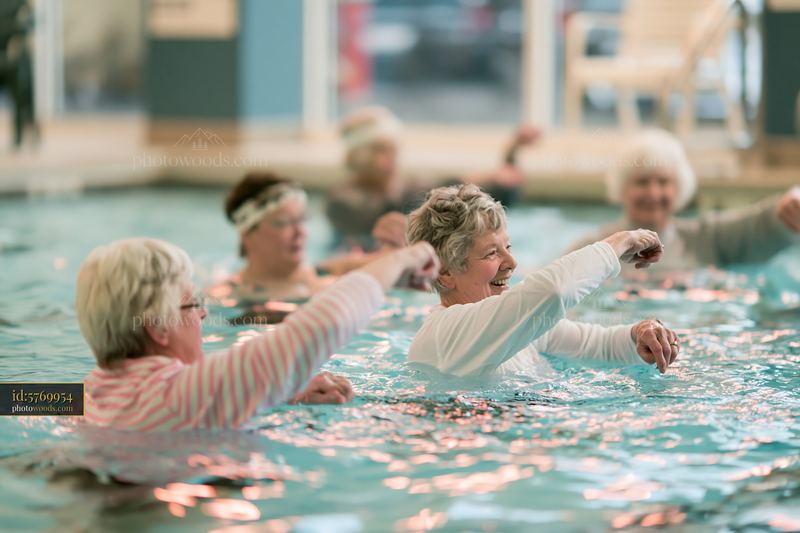 Senior women participating in aqua aerobics class in a pool