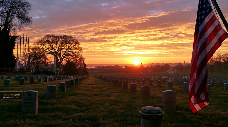 American flag waving at sunset over Arlington Cemetery