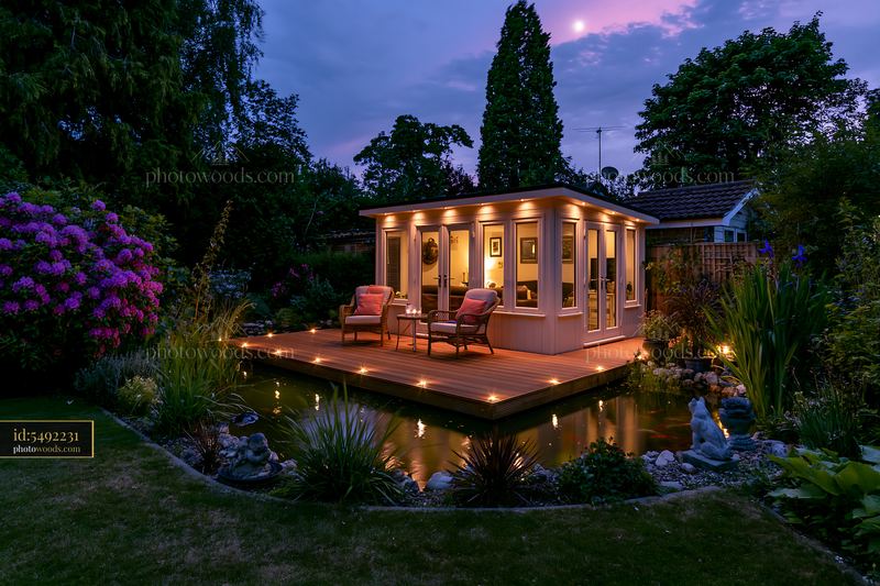 Premium garden room with illuminated deck in evening light