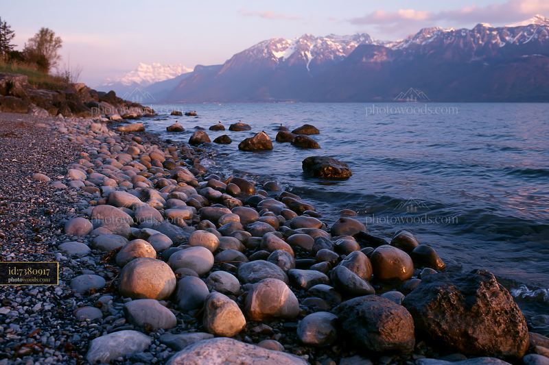 Swiss landscape in golden light over rocky shoreline