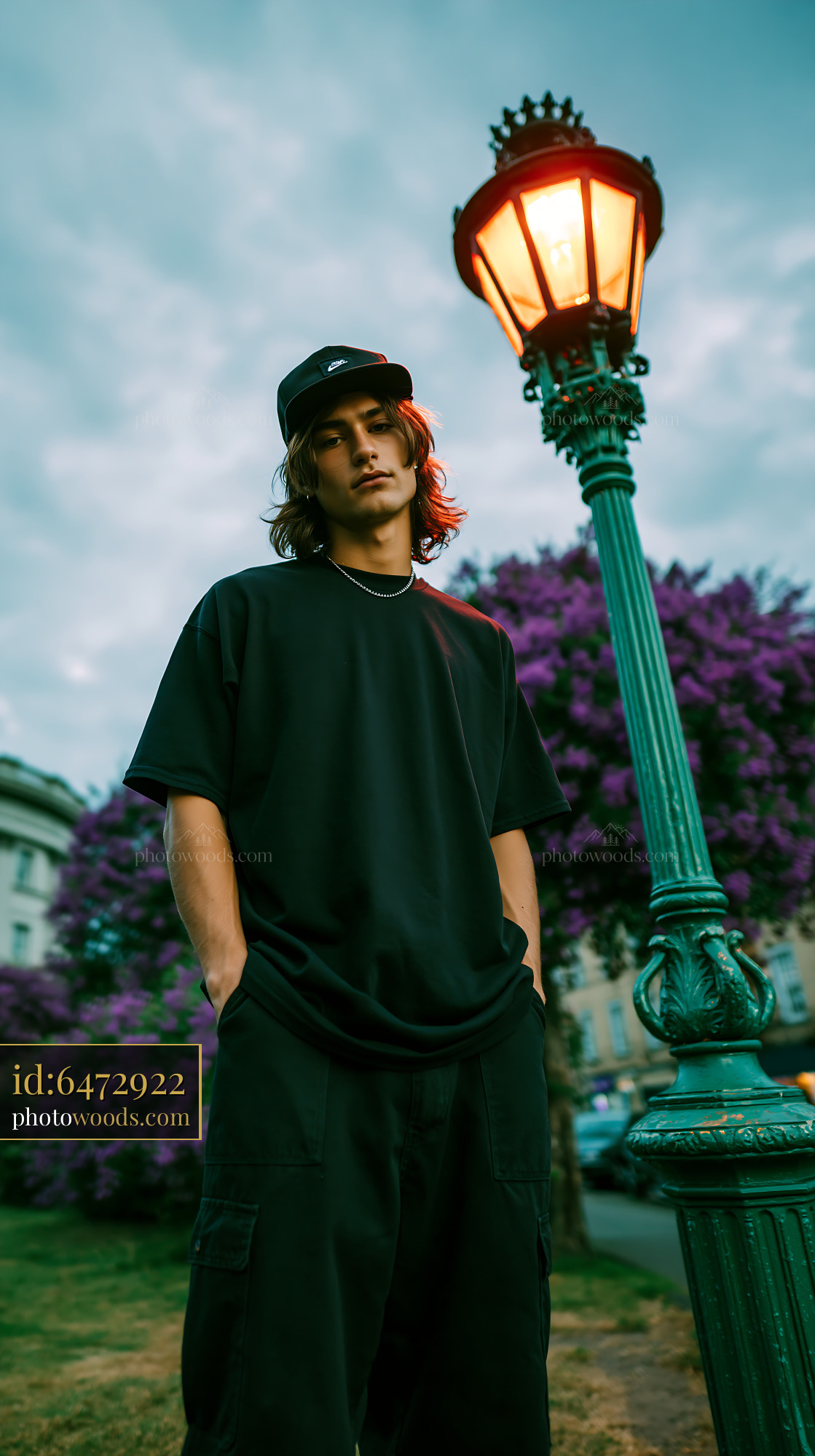Skater Man Standing Near a Vintage Lamp Post in a Park