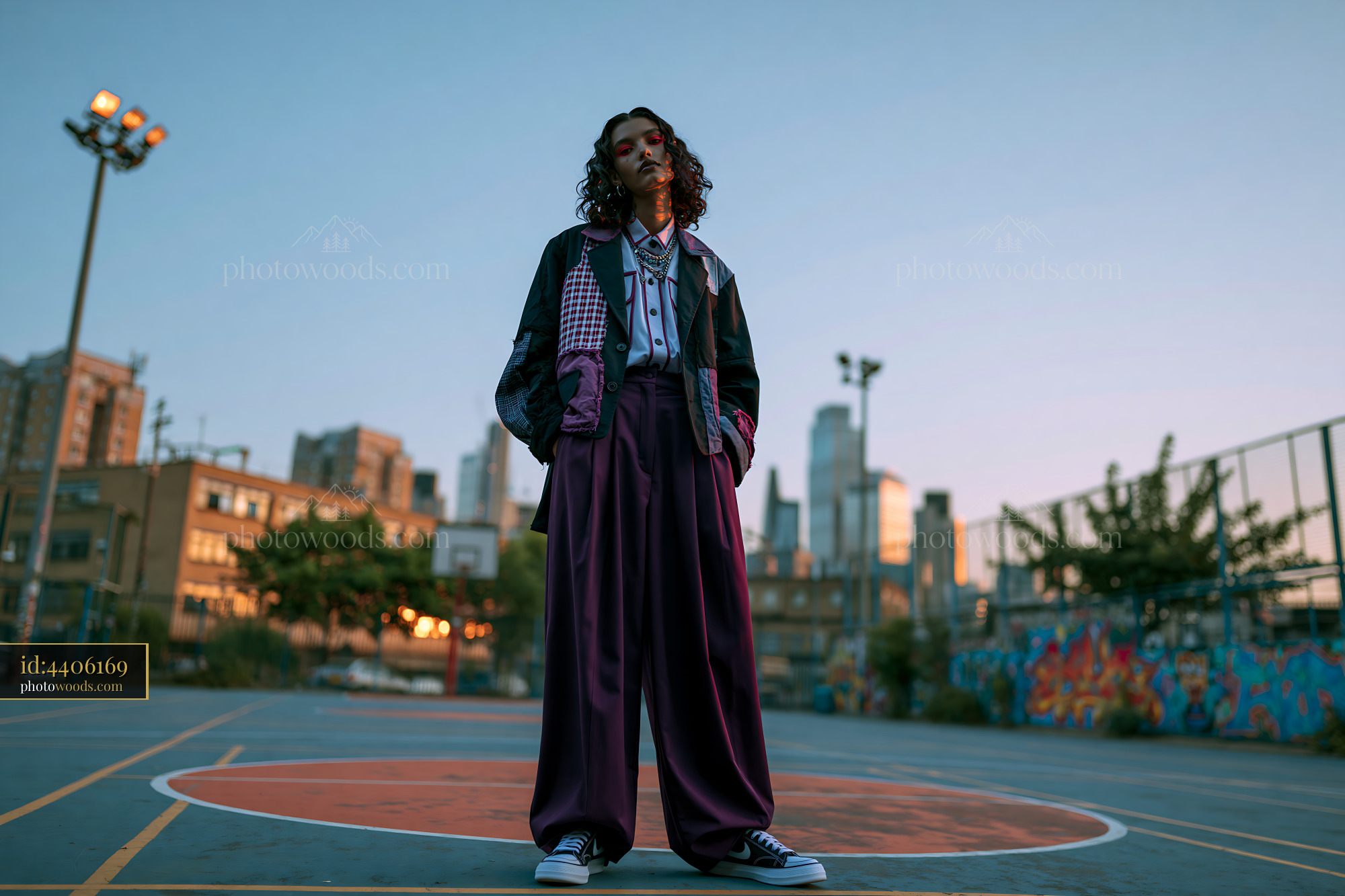 Androgynous Model Posing on Basketball Court at Sunset