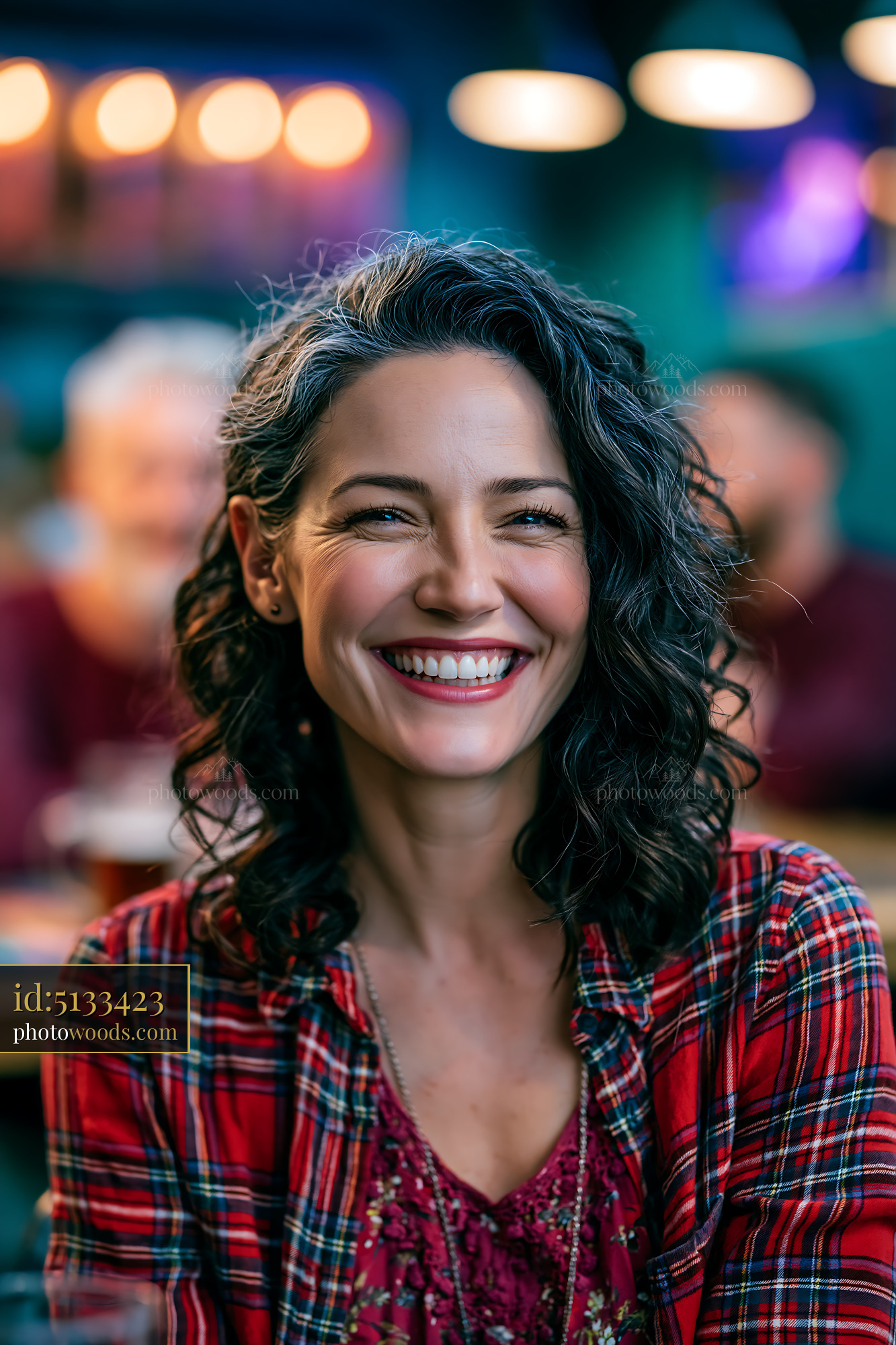 Woman Smiles Brightly in a Cozy Bar With Warm Lighting