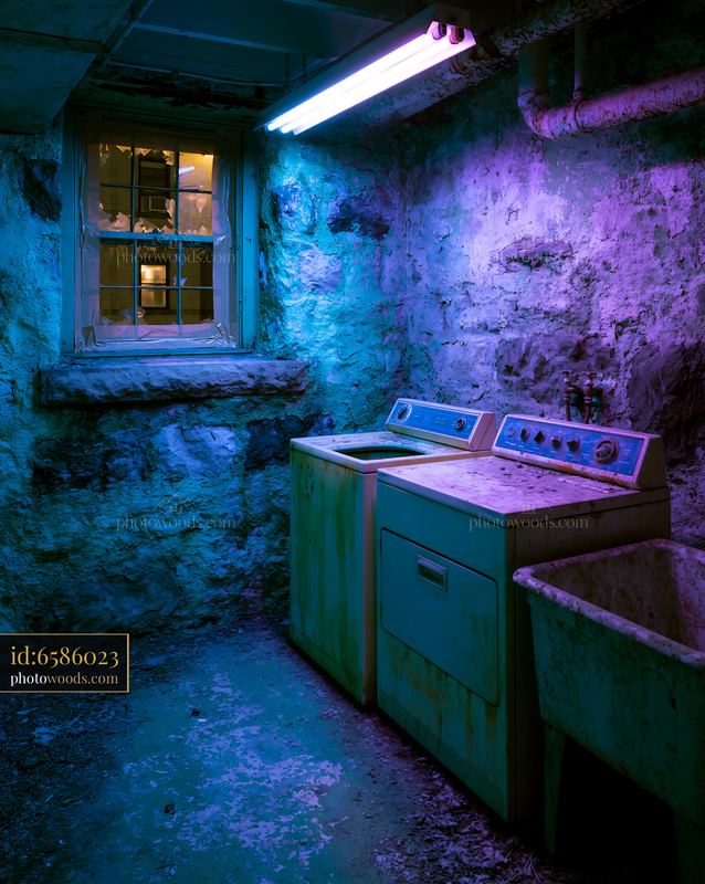 Neglected Basement Laundry Room With Broken Appliances in Poor Light