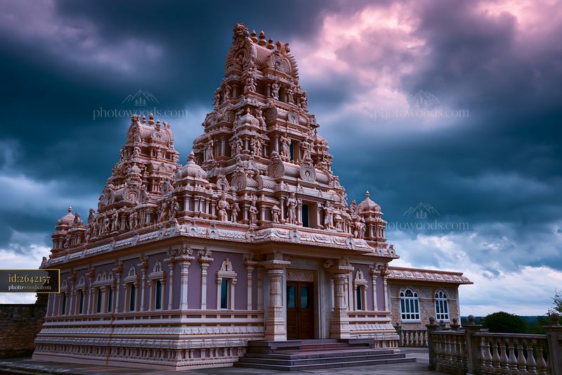 Hindu temple with intricate architecture under cloudy sky