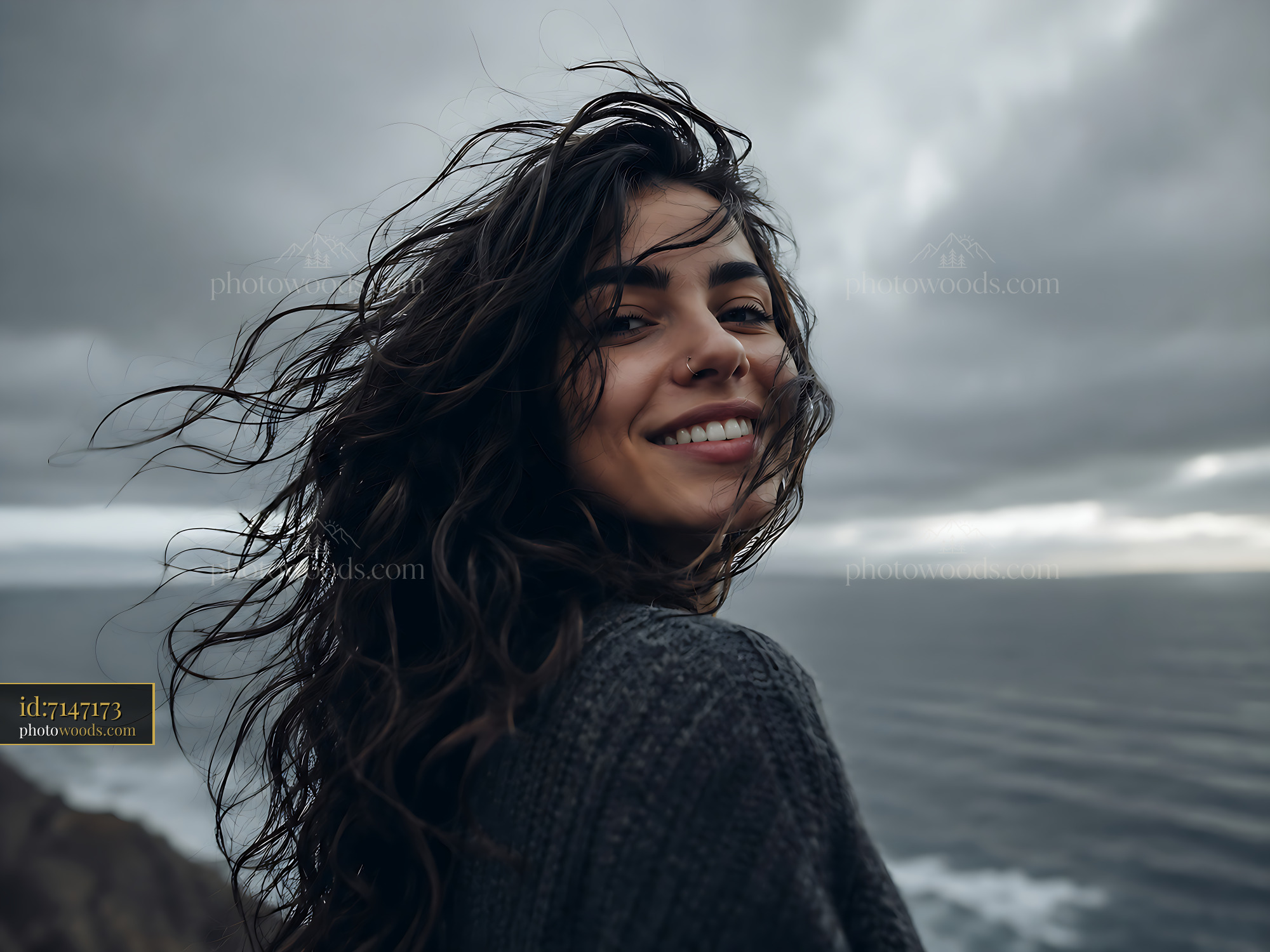 Woman Smiling With Wind-Blown Hair Near Ocean Cliff