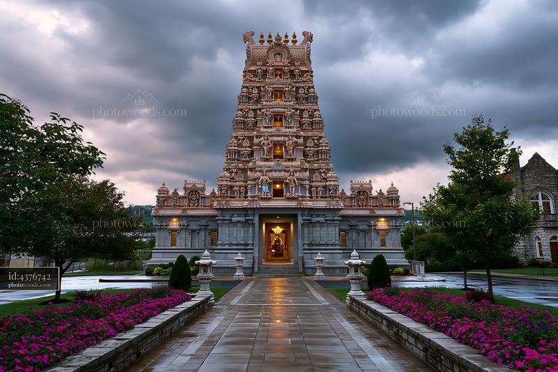 Hindu temple with detailed architecture under cloudy sky