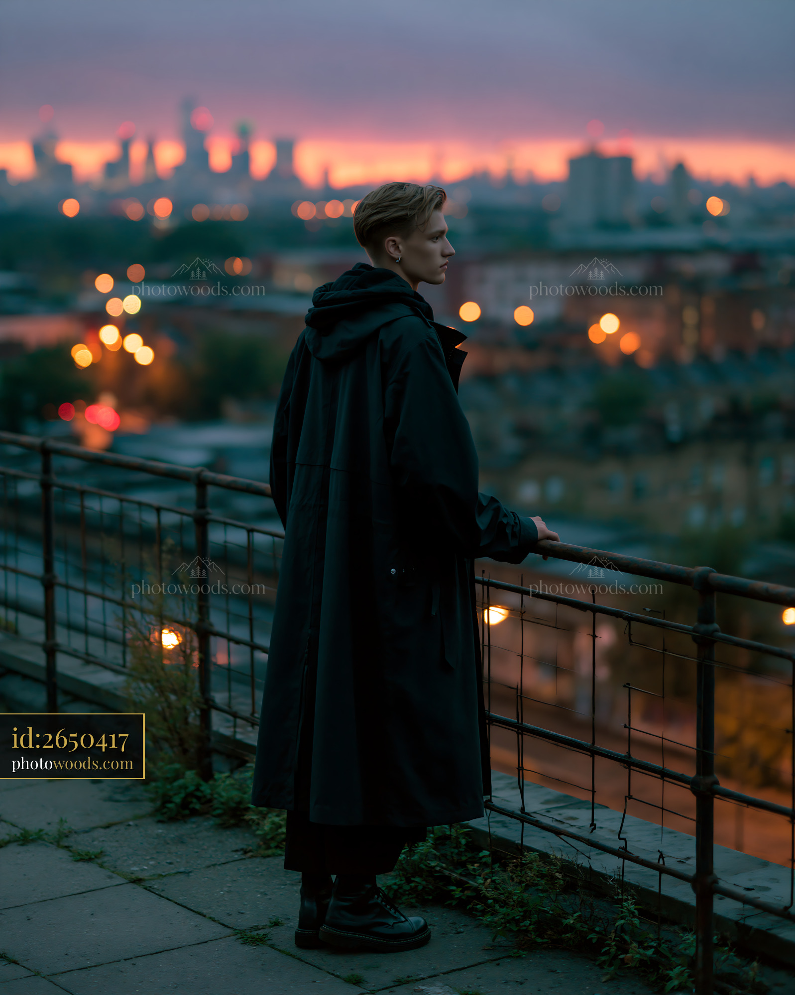 Model in a Longline Technical Shell Coat Against a City Skyline