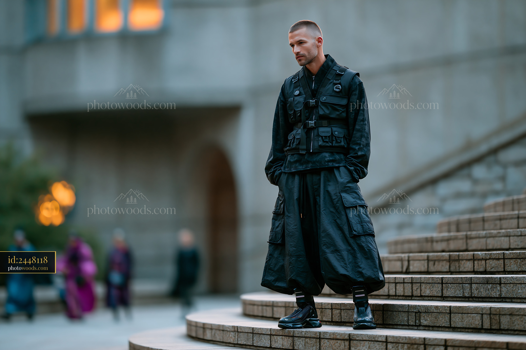 Man in Tactical Vest and Culottes on Urban Steps at Dusk