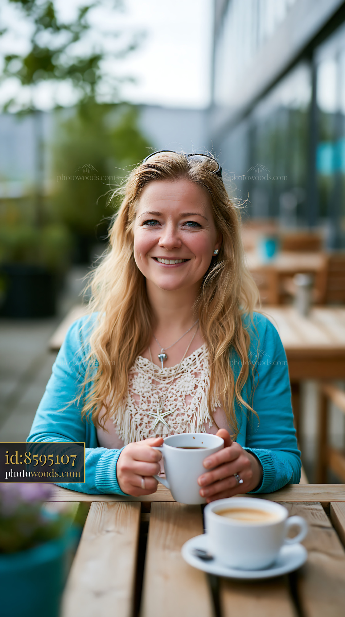 Woman Relaxing at a Cafe Holding a Cup of Coffee Outdoors