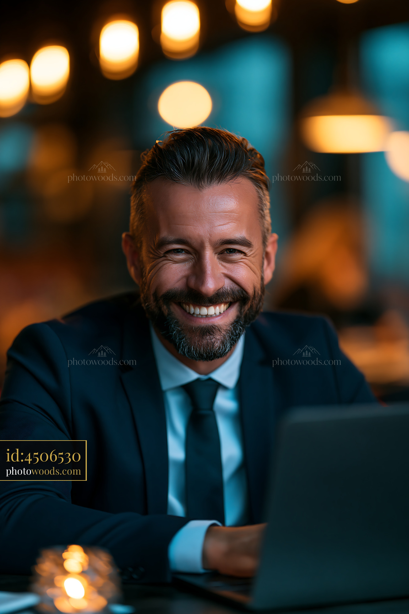 Man in Suit Smiles While Working on Laptop at Cozy Cafe