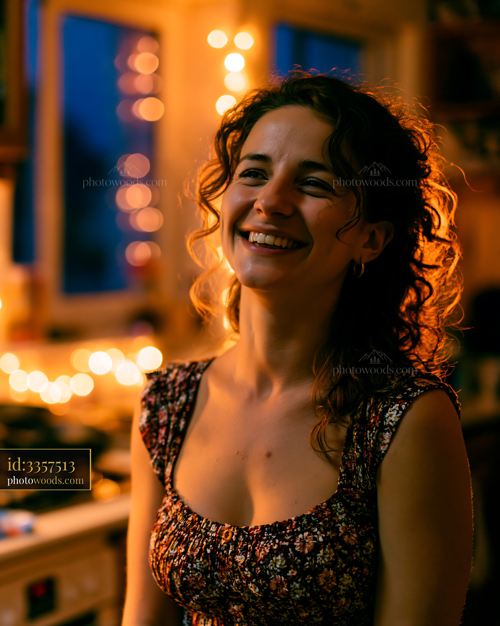 Woman Smiling in Cozy Kitchen at Night With Warm Lights
