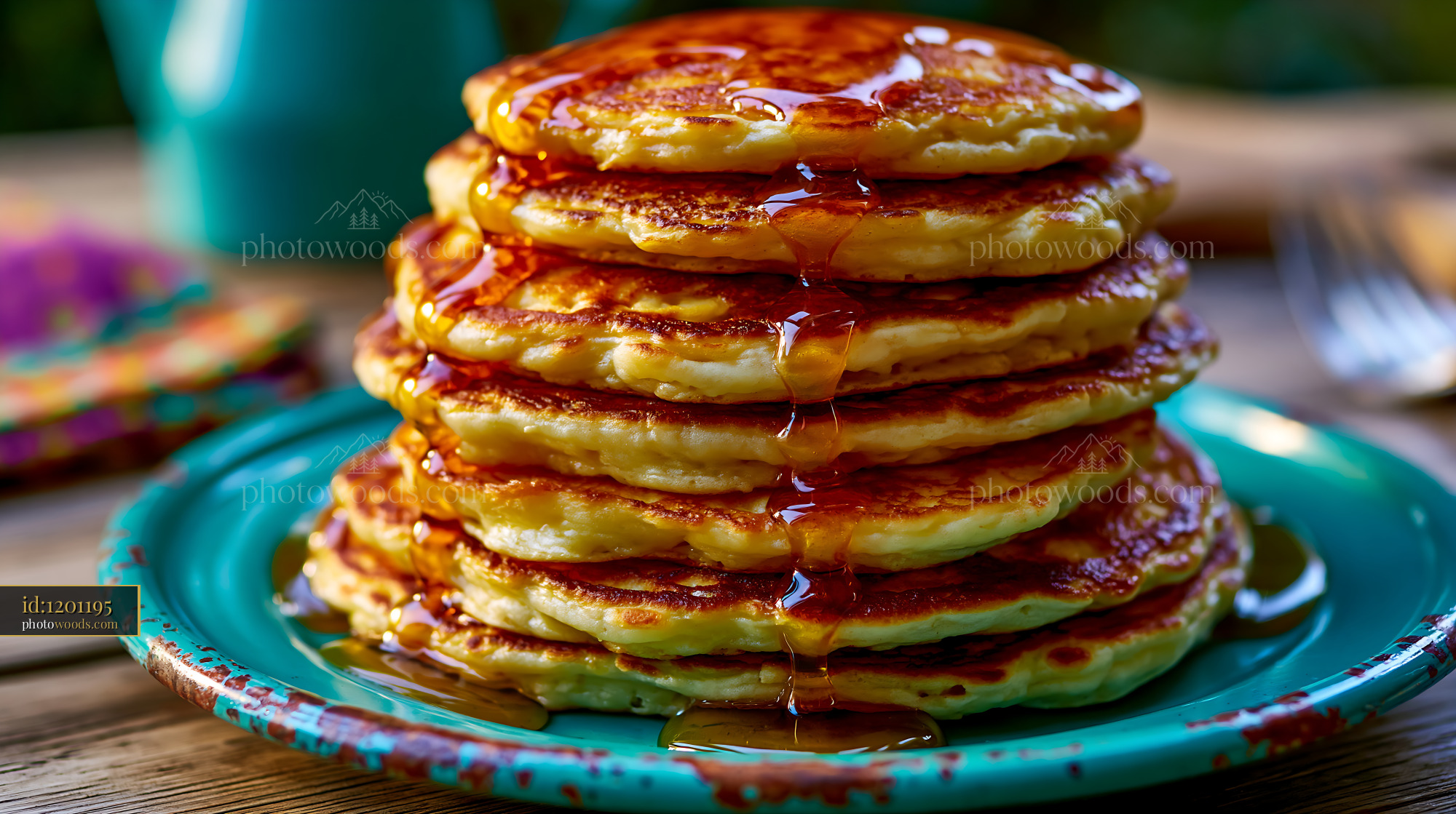 Stack of pancakes with maple syrup on a colorful plate