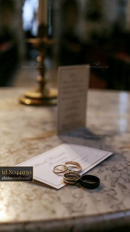 Wedding invitation and rings on a church altar